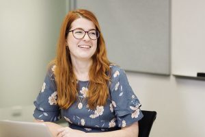 Sitting at computer smiling